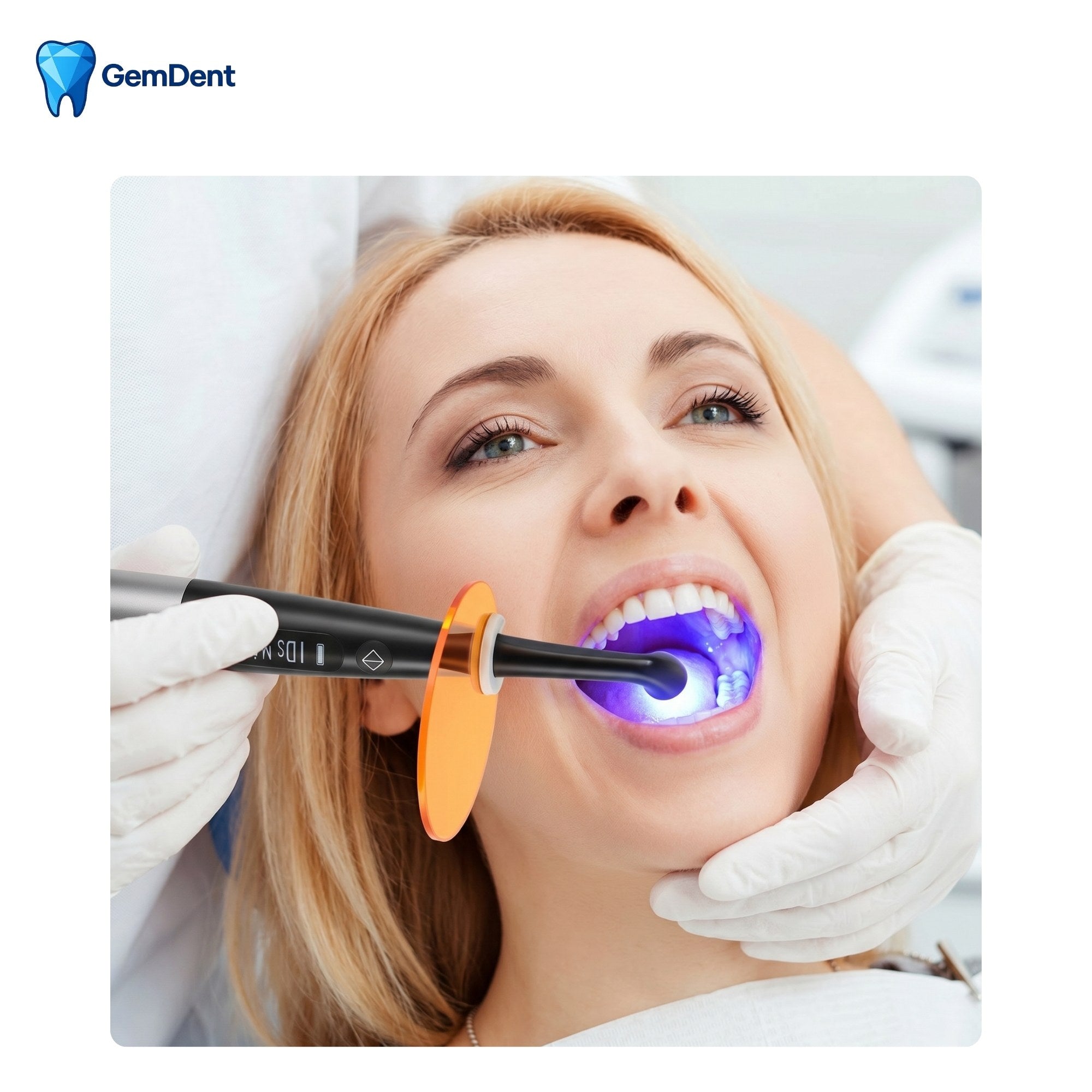Dentist using LED curing light to cure dental composite resin blue light curing GemDent Luma GDLU100 